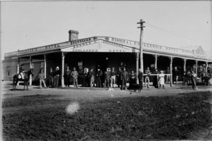 The Coolgardie Hotel, 1896 Mrs Mary Ann Shannahan is standing beside the telegraph pole with x