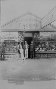 The Exchange Saloon Barbershop owned by R. Pitchford, and H M Jerger, Goldsmith and Watchmaker, Coolgardie, 1899