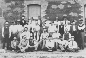 Alfred Sirr (extreme left) with the official staff of Sons of Gwalia Mine, ca.1900