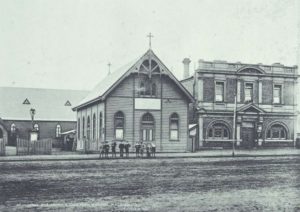 The Old St Johns Parish Hall next to Council Chambers, Brookman St, Kalgoorlie with St Johns Church in the background - 1910