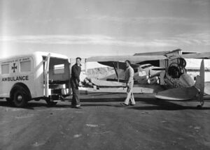 A Royal Flying Doctor Service patient is transferred from a Connellan Airways Fox Moth to an ambulance at Alice Springs in 1954 Photo - Wikipedia