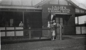 Lillis’s Railway Hostel and Dining Rooms – Opposite the Coolgardie Railway Station. On verandah – May LILLIS (Wife of Thomas Lillis), at the gate baby Brian REGAN his mother, Kathleen nee LILLIS, Friend Mary BRIMSTONE, young girl, Maureen REGAN (sister to Brian), Taken about 1934 – Photo from Brian REGAN of Busselton.