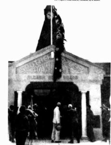 The Leiutenant Governer unfurling the flagon the town hall