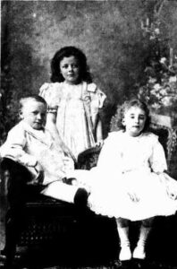 Three of the Glowrey children - Evelyn standing, Lindsay and Irene seated.