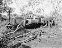 Two men and a bogged truck in the mulga in the Murchison 1930 - Photo SLWA