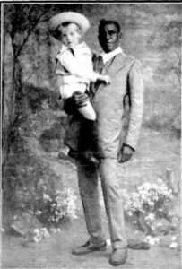 The boy Scott who was lost in the bush near Leonora with tracker Tommy Jones who restored him to his parents – Photo by Charles Wilson.
