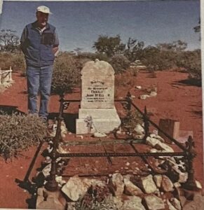Bill McKellar next to his uncles grave at the Nannine Cemetery.