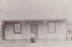 Mrs Lydia Louisa BARCLAY outside her house in Toorak Tce, Coolgardie in 1899. She is holding her first child, Jessica Estelle Barclay, born 1899.