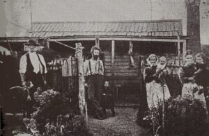 The home of William Hickey in Clunes c 1882: L-R – Thomas Henry Hicky (with dog) – William – James William – Eliza Hickey holding Francis Leo – Annie Agnes holding Edward Thomas.
