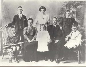 The parents of Standing: Charles Herbert, Eugina Victoria, John Arthur. Seated: Robert, Anais (Mother), Edith, Arthur (Father), Angus