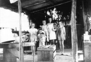 Children in a bough shed attached to their home - Photo Phil Bianchi