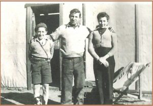 Alec and Ena with their father Virgilio Epis and trusty dog Pippi outside the family home with its cloth walls at Yilgangi Queen mine c 1947 - Image Alec Epis.
