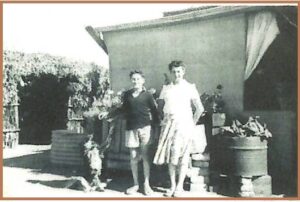 Alec and Ena Epis at Yilgangi Queen in the two room house on the site of the mine c 1949. Note the bough shed on the left made from the boughts of a gum tree to provide welcome respite from the oppresive heat - Image Alec Epis.