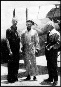 Discussing rescue efforts: Left is Major N Brearley who met pilot Baker and Mr N Stuckey (with bandaged head) on their perilous return from the lake.
