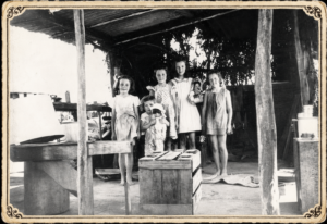 Children in a bough shed attached to their home - Photo Phil Bianchi