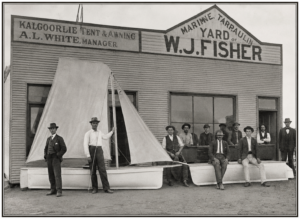 Boat building for the lake at Nannine. April 1900. W.J. Fisher sitting on boat with hands in lap.Next to A E Whitchurch - Cycle Agency. From the above photo it appears that W J Fisher took over from A E Whitchurch. - Robin Panousieris